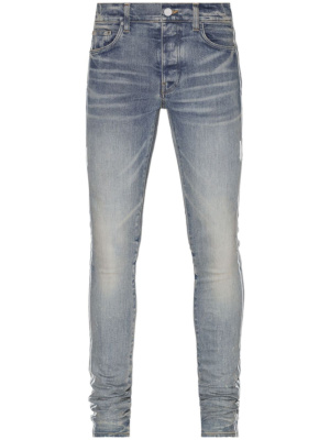 

A. Track skinny jeans, AMIRI M.A. Track skinny jeans