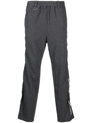 

Logo-print zipped trousers, Undercoverism Logo-print zipped trousers