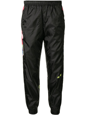 

Graphic-print track pants, AAPE BY *A BATHING APE® Graphic-print track pants